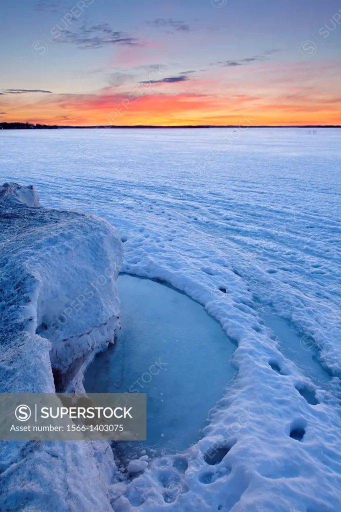 An evolving landscape of thawing and shifting ice graces Lake Simcoe in the early spring warmth. Georgina, Ontario, Canada.