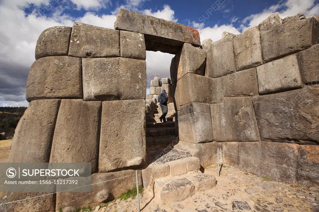 Visitor going through the Stone door at the The Saqsaywaman