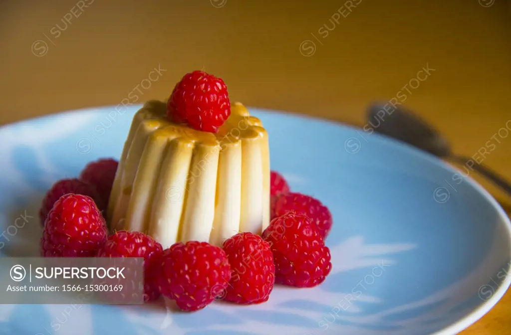 Creme caramel with raspberries.