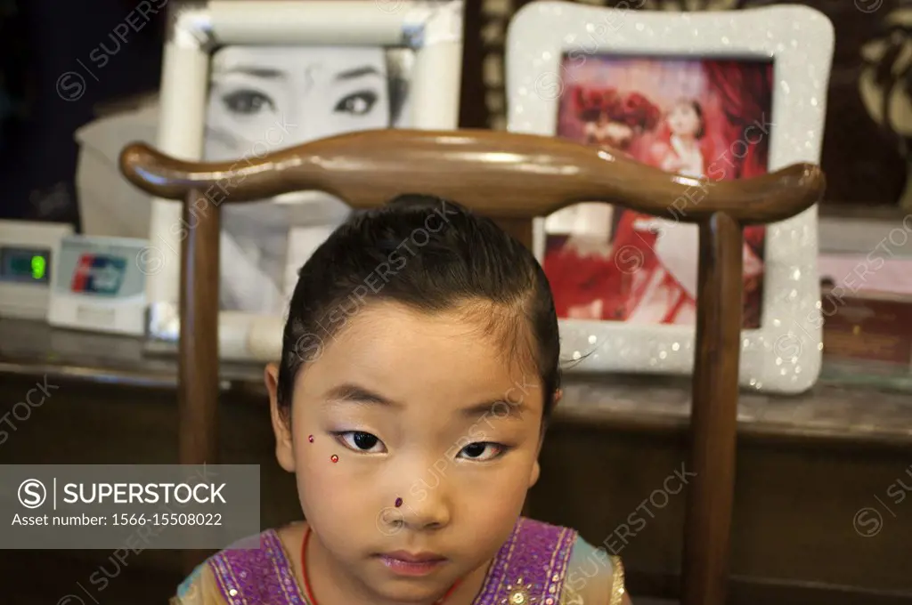 Muslim quarter of Xian, Shaanxi, China, Asia. Silk road, Huimin Street, Beiyuanmen Moslem market. A girl makeup inside a photo studio specializing in ...