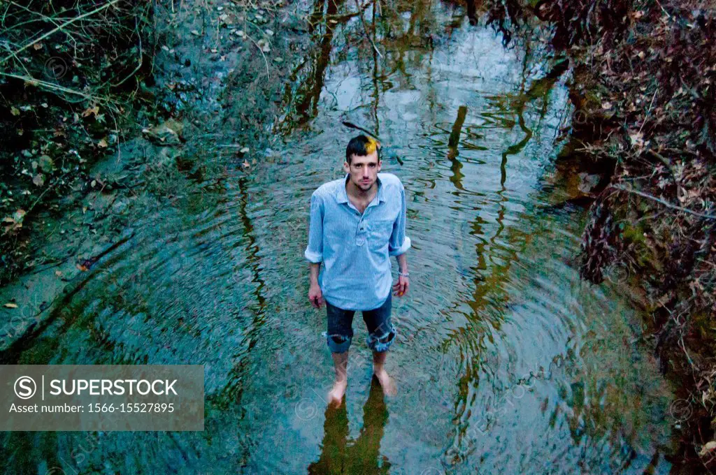 Caucasian male model poses for pictures in the nature.