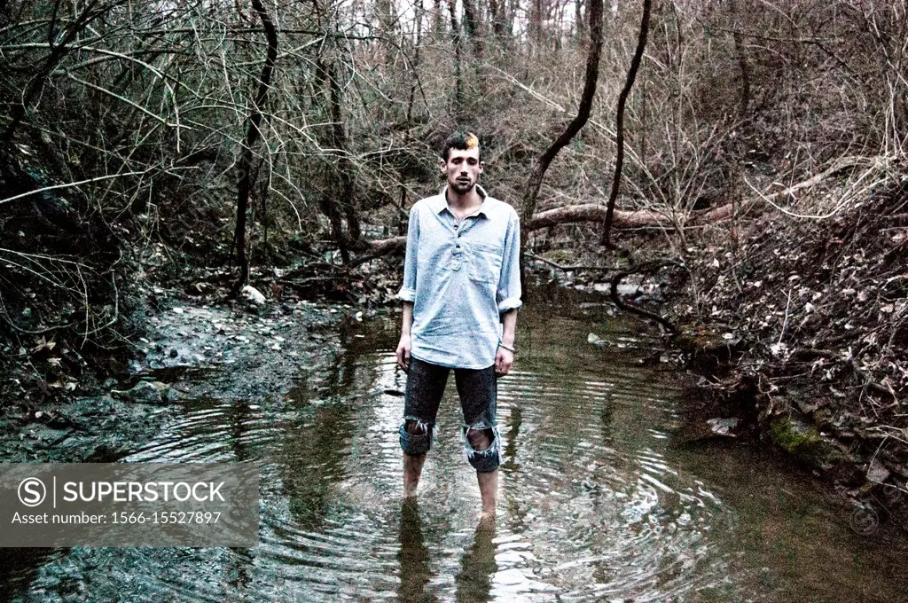 Caucasian male model poses for pictures in the nature.