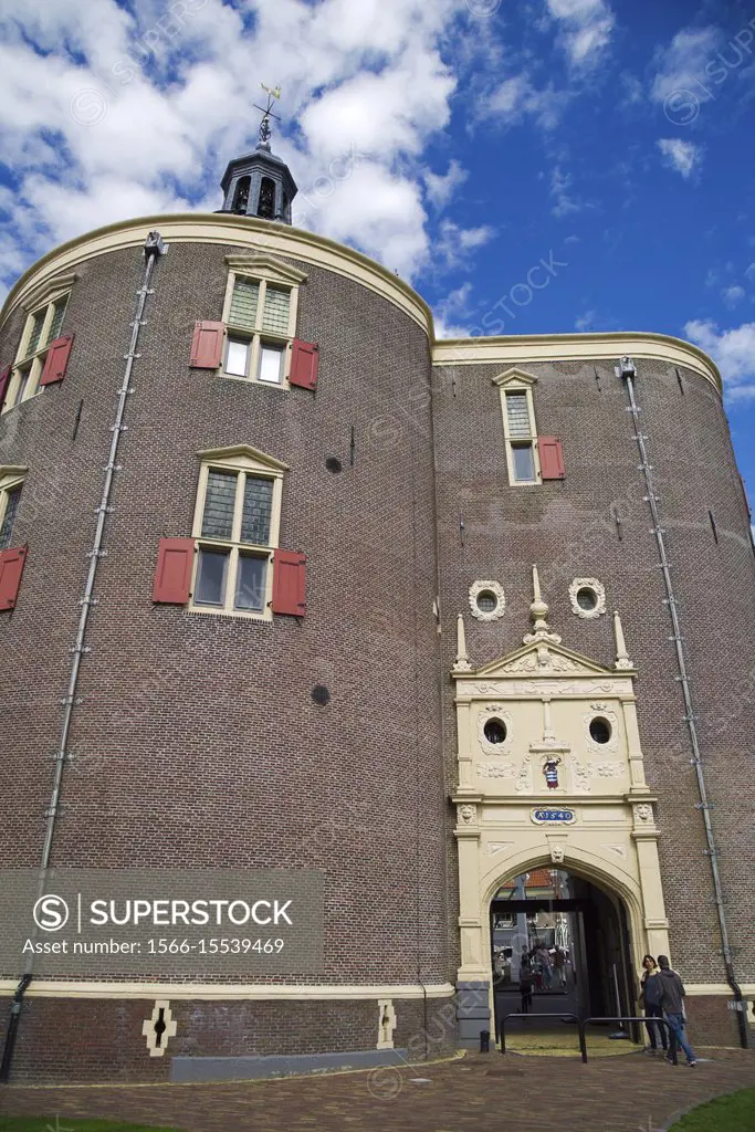 Enkhuizen, a small town in northern Holland, a historic building, entrance to the historic city center, under a blue sky with clouds.