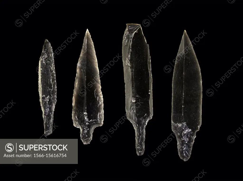 Black obsidian arrow heads. Catalhoyuk Collections. Museum of Anatolian Civilisations, Ankara. Against a black background.