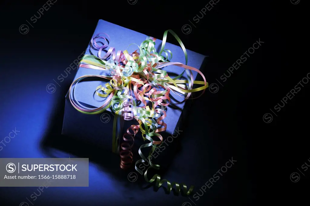 Blue gift wrapped present with colorful ribbons