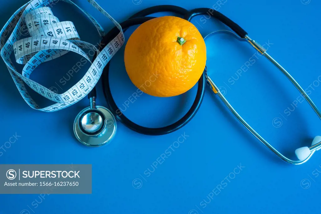 An orange with a stethoscope and a meter.