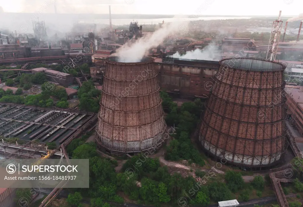 Industrial landscape at the sunset, aerial view. Smoke coming out from factory chimneys. steelworks Industrial buildings. Environmental disaster. Harm...