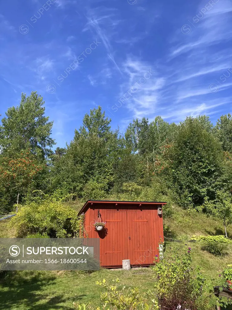 Wooden shed with blue sky behind. .