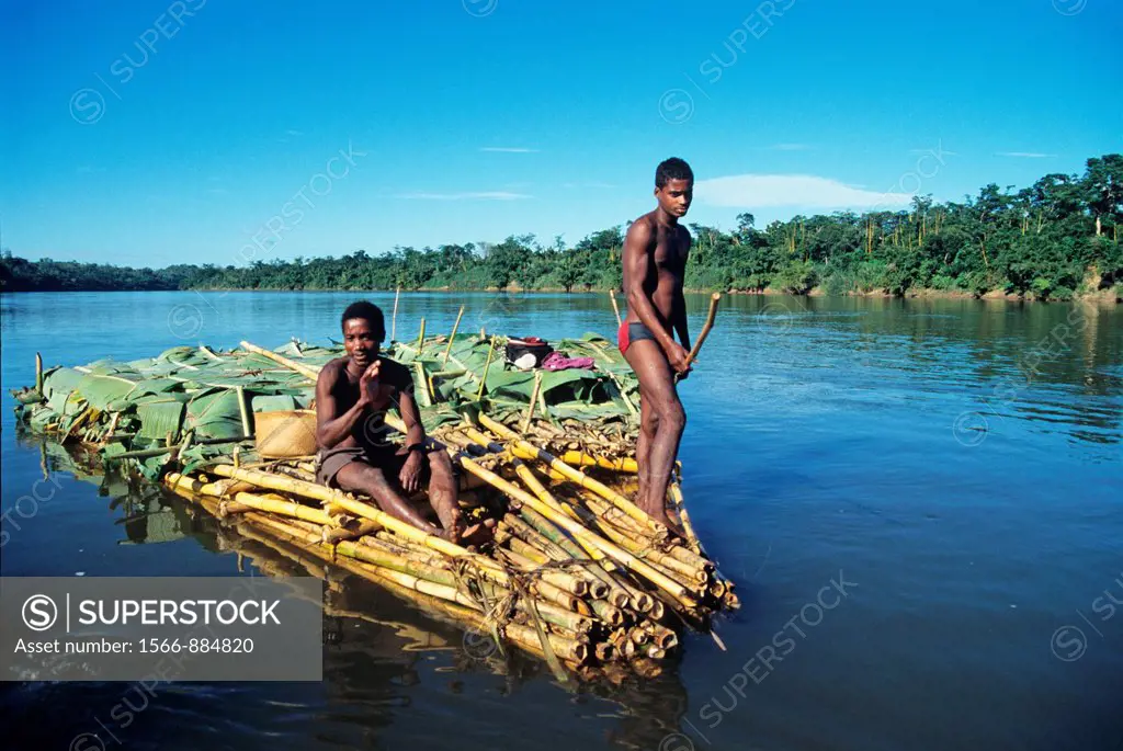 men carrying bananas on a bamboo raft, Canal des Pangalanes