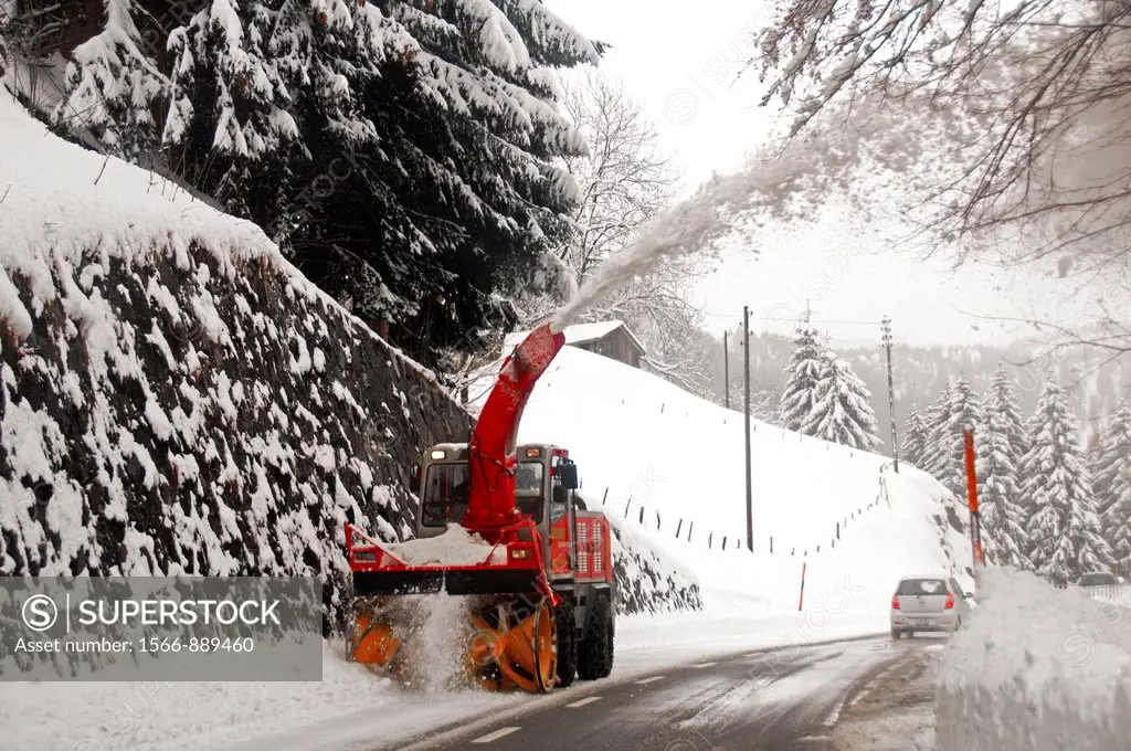 Machine Cleaning Snow from the Road, Snowblower throwing snow high and away  From the Road, Snow cleaning Machinery, Switzerland - SuperStock