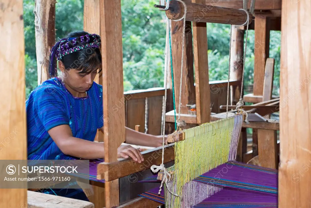 Native girl weaving on a loom in San Antonio Palopó, Sololá, Guatemala