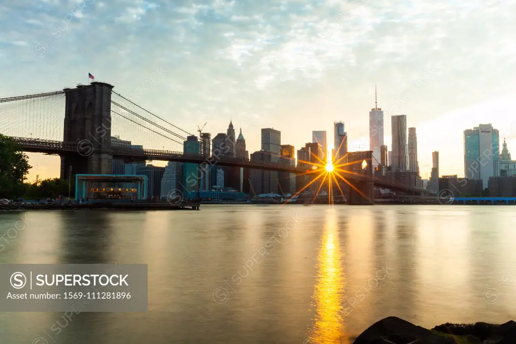 Manhattan skyline and Brooklyn Bridge at sunset