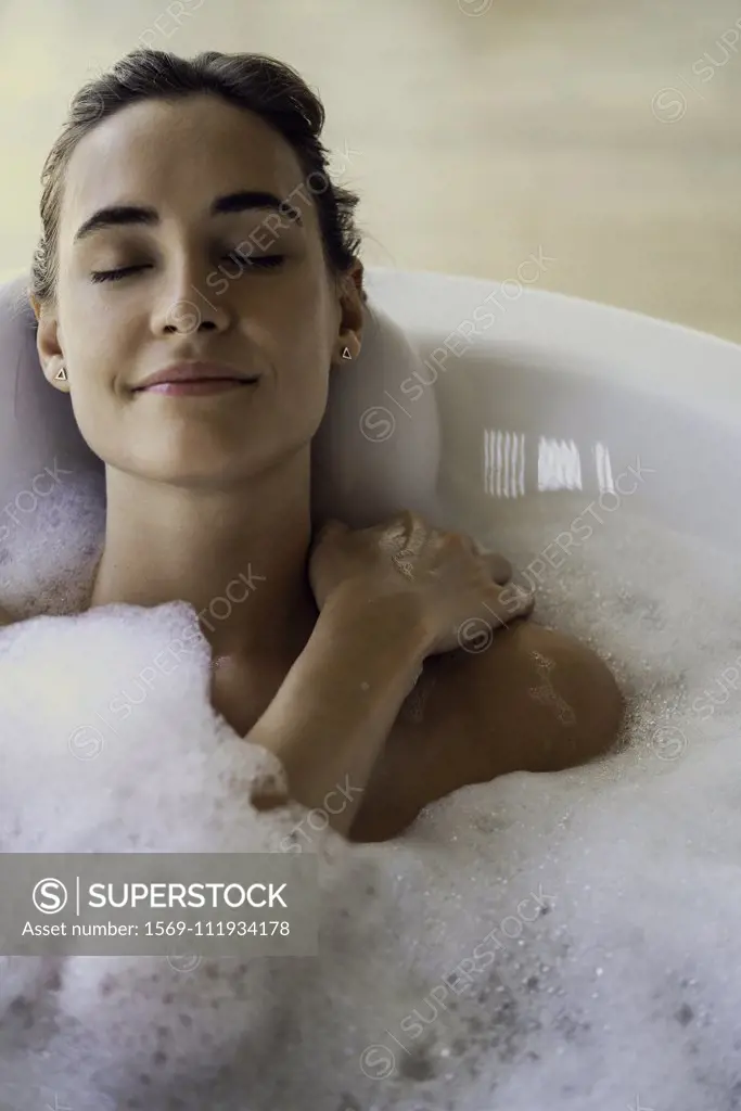 Young woman relaxing in bathtub