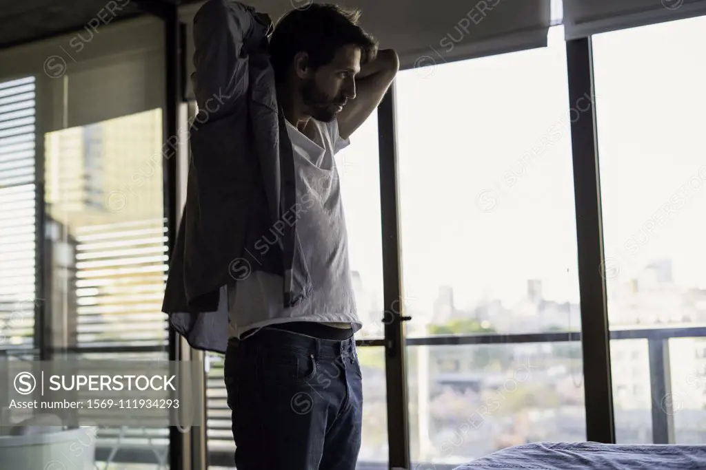 Young man getting dressed