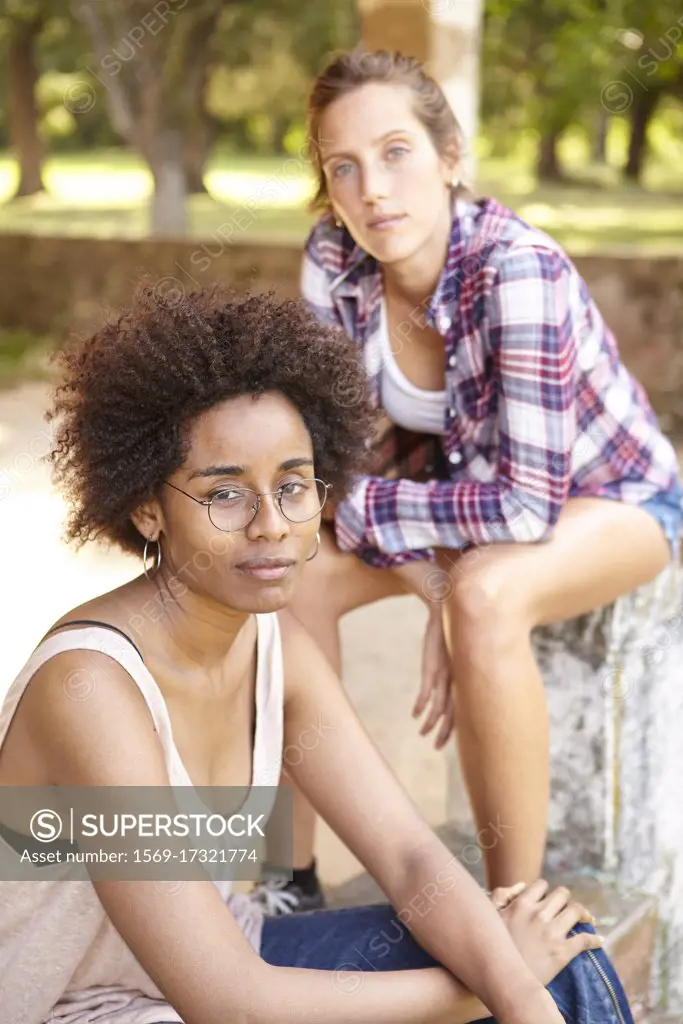 Beautiful young women sitting outdoors