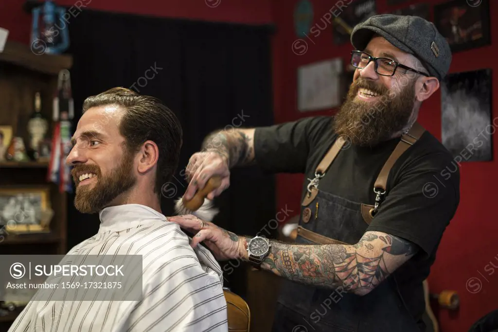 Hairdresser cleaning client's neck