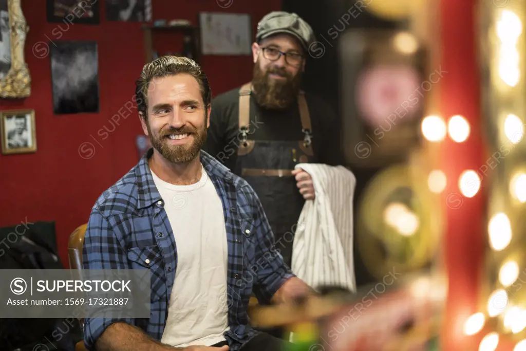 Man looking at his haircut in mirror