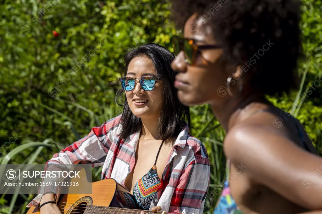 Beautiful young women having fun together at pool party