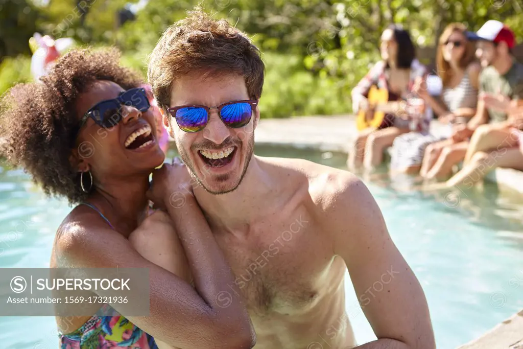 Young couple embracing in the swimming pool