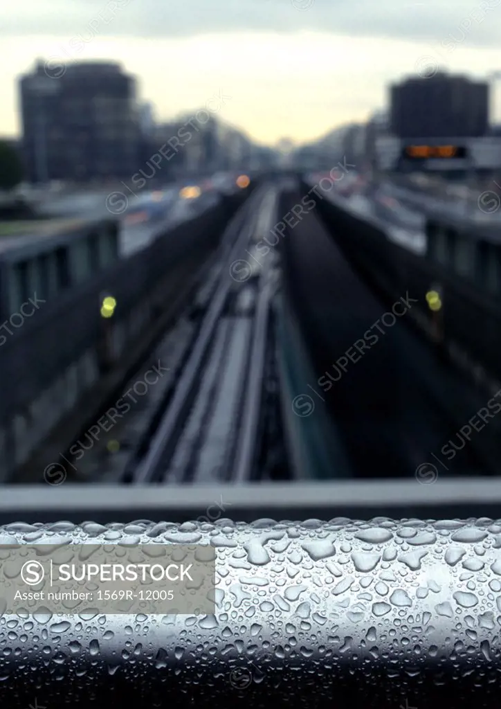 Water drops on rail overlooking traintracks