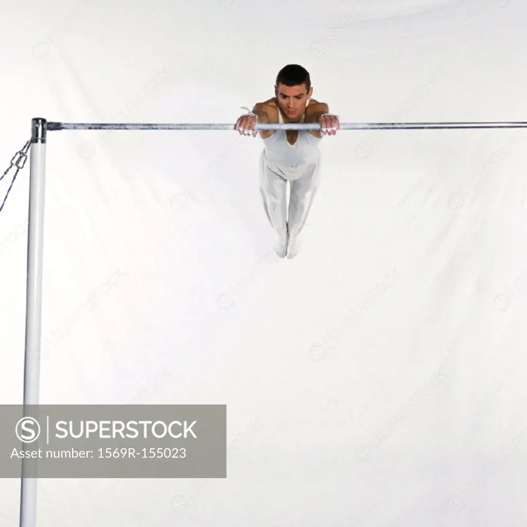 Male gymnast swinging on horizontal bar