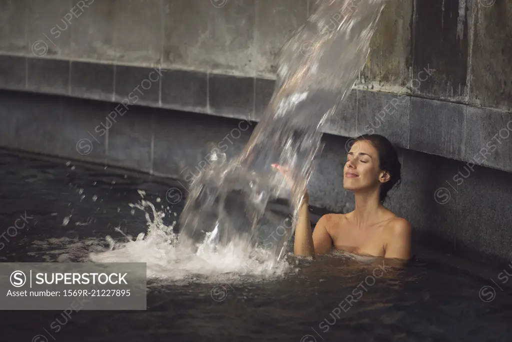 Woman soaking in spa pool