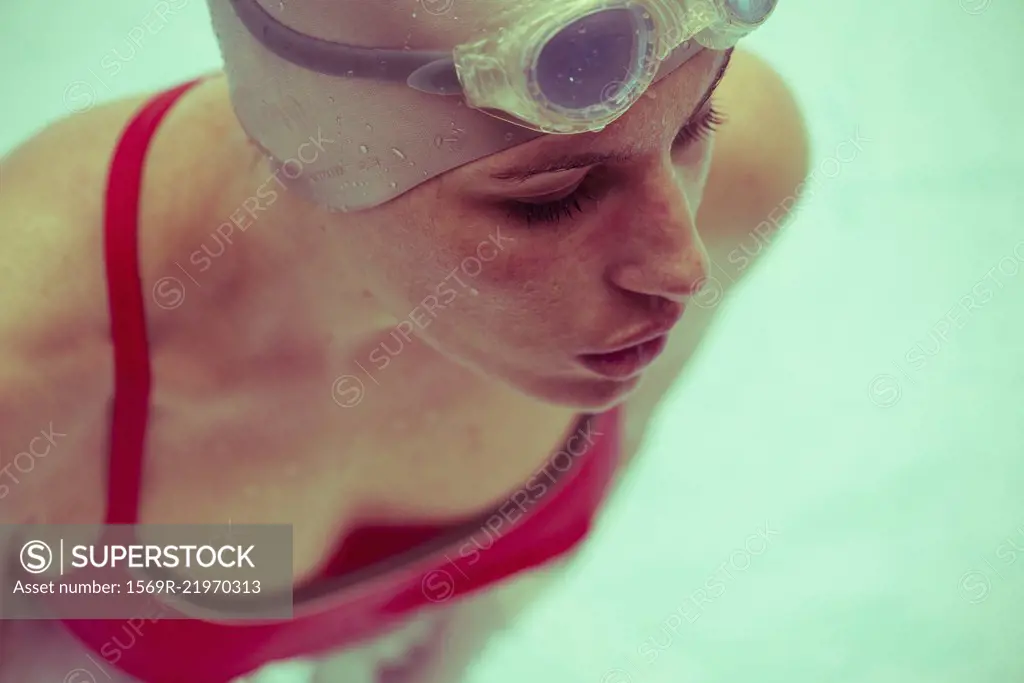 Woman swimming in pool, close-up