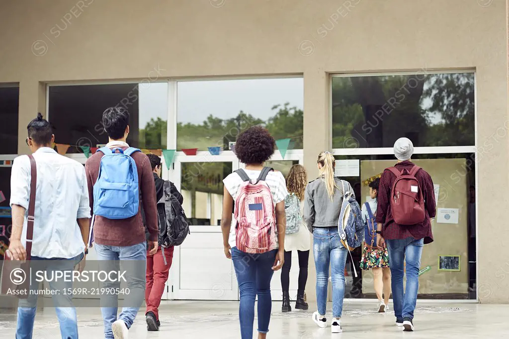 College students walking on campus, rear view