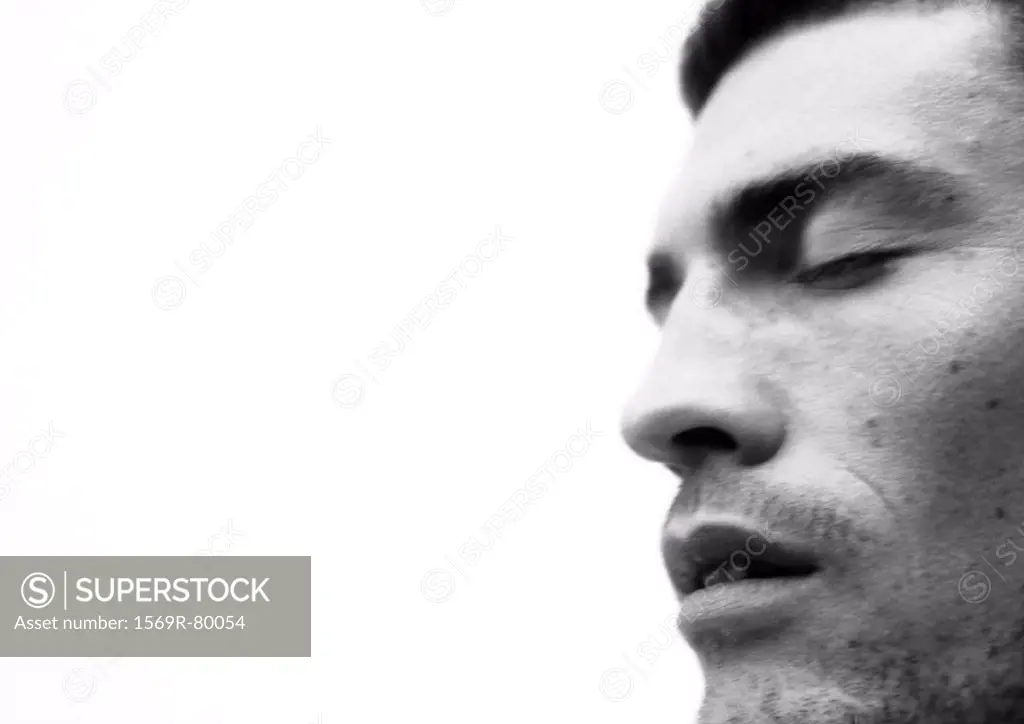 Man´s face with eyes closed and mouth open, close-up, side view, black and white