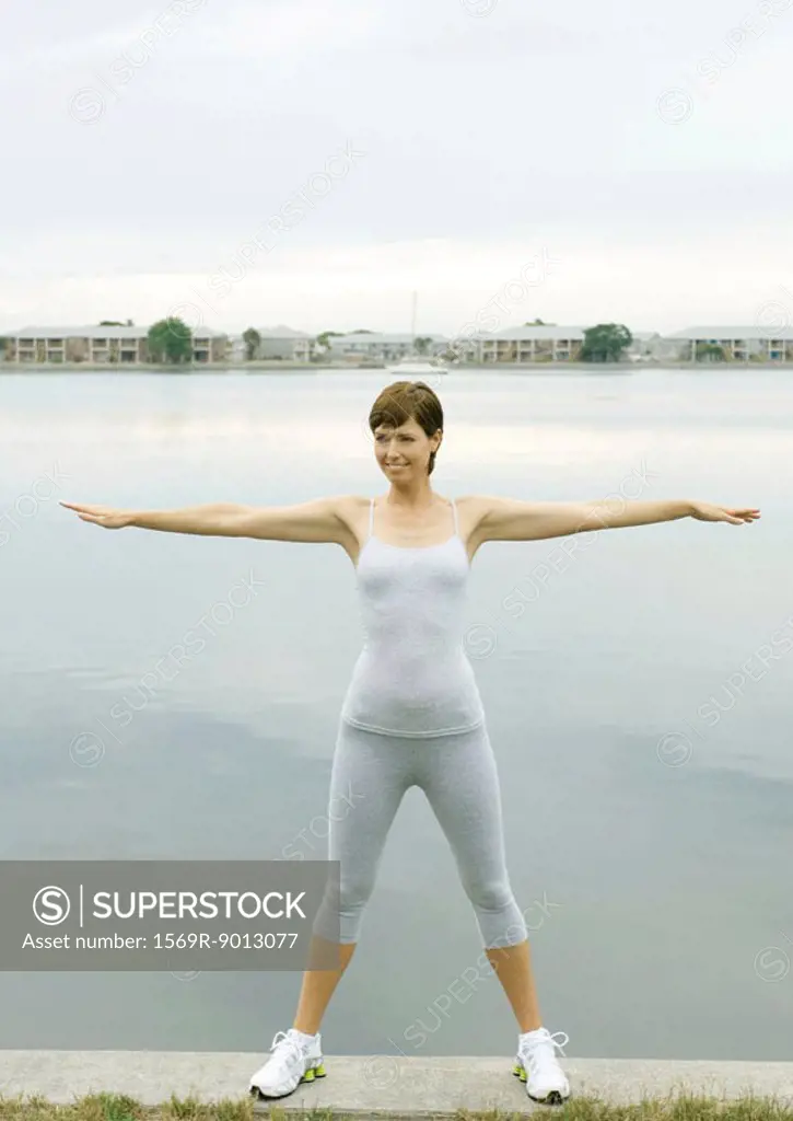 Woman exercising, lakeside