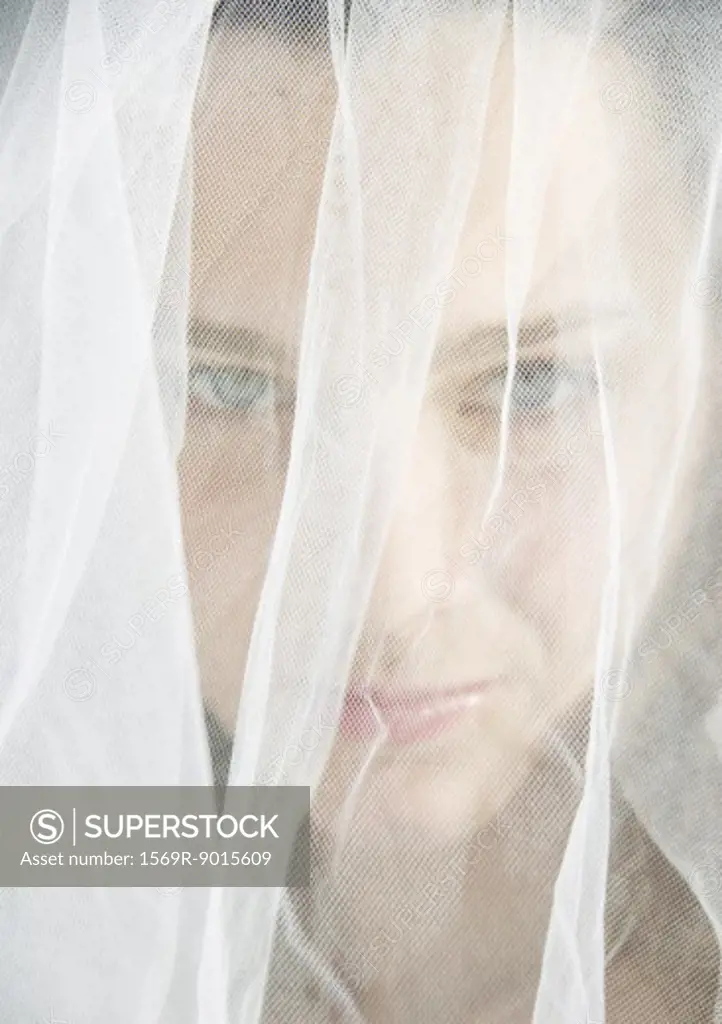 Preteen girl wearing wedding veil