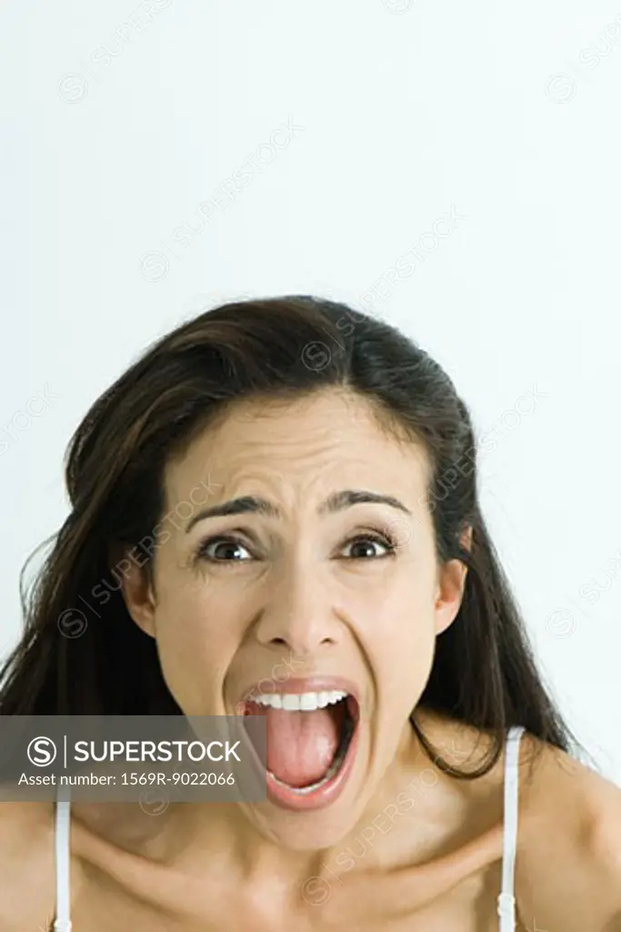 Woman screaming, looking at camera, head and shoulders, portrait