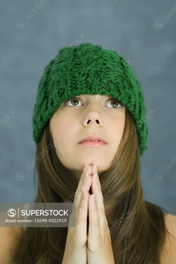 Teenage girl praying, portrait