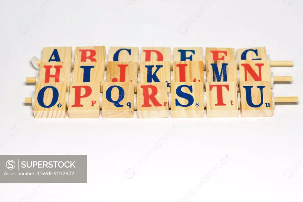 Wooden alphabet blocks lined up, close-up