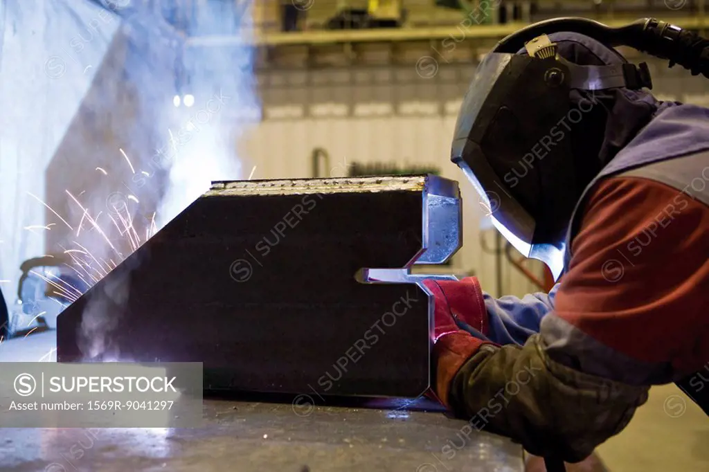 Coated textile plant, maintenance workshop, welder performing arc welding