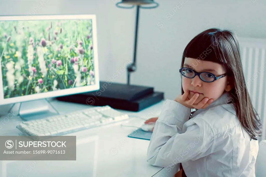 Girl sitting in front of desktop computer