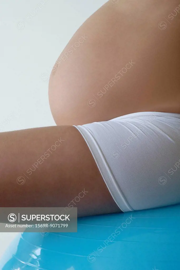 Woman´s pregnant belly, side view