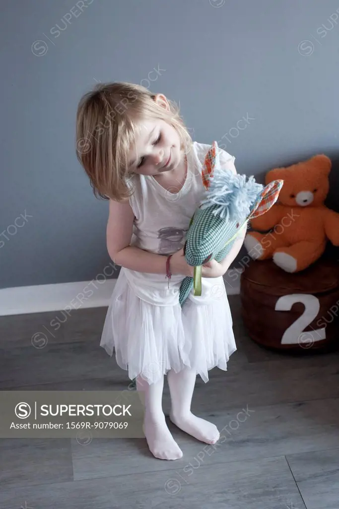 Little girl playing with hobby horse