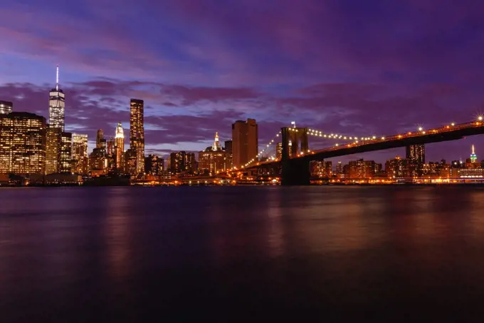 Manhattan skyline and Brooklyn Bridge at dusk