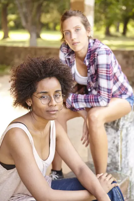 Beautiful young women sitting outdoors