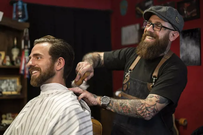 Hairdresser cleaning client's neck