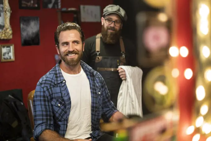 Man looking at his haircut in mirror