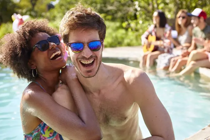 Young couple embracing in the swimming pool