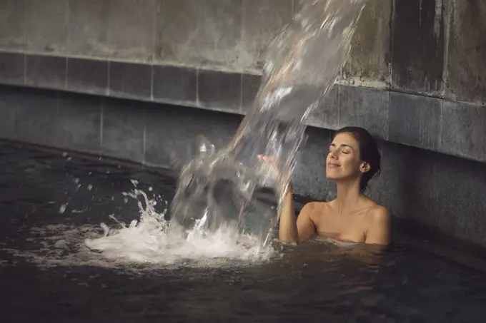 Woman soaking in spa pool