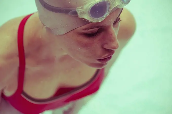 Woman swimming in pool, close-up