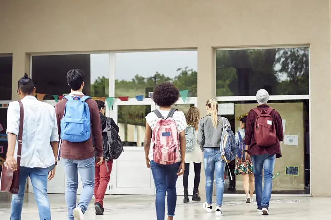 College students walking on campus, rear view