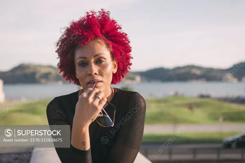 Portrait confident, serious woman with red hair