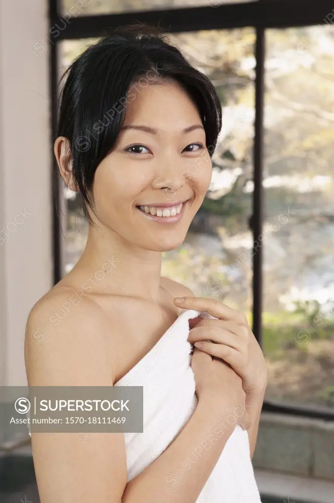 Portrait beautiful young woman in bathrobe at spa