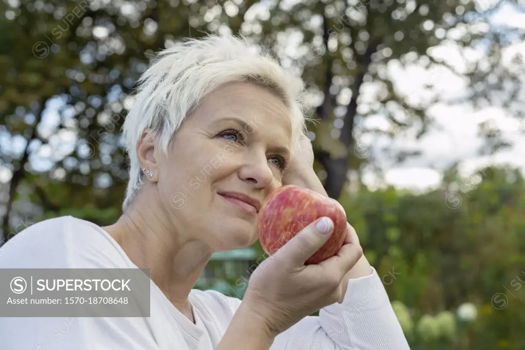 Woman eating fresh red apple