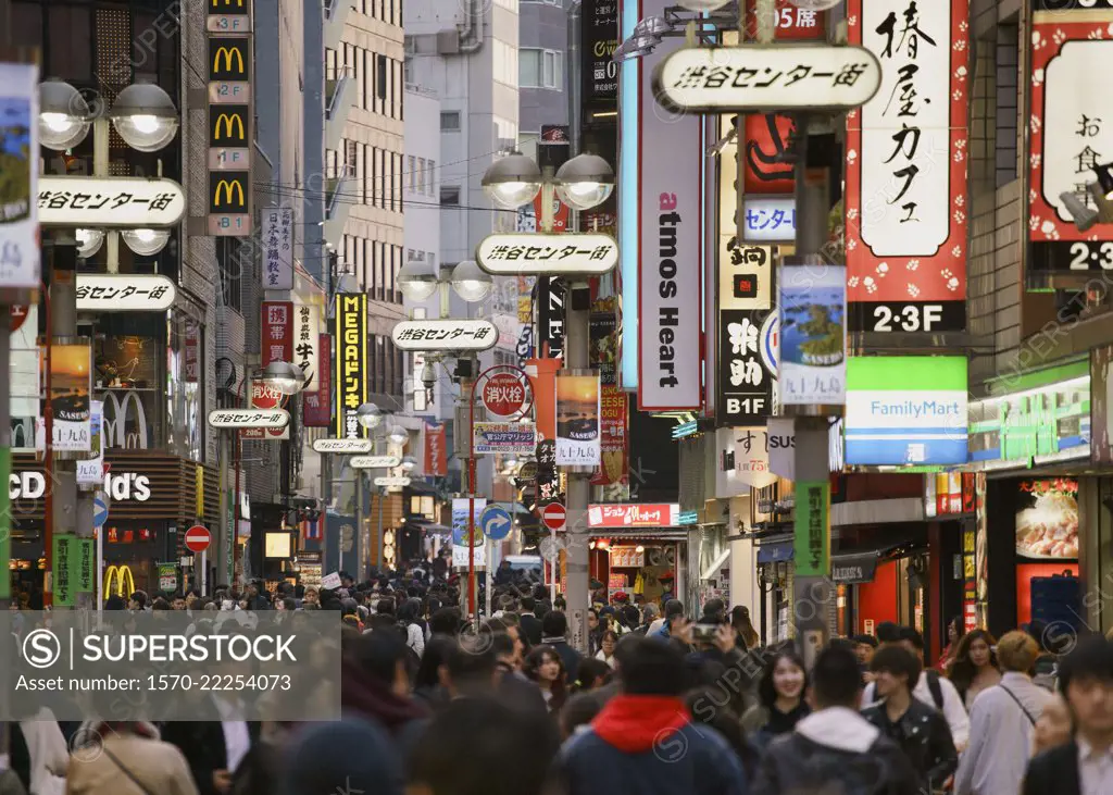 Pedestrians on bustling modern city street, Shibuya, Tokyo, Japan